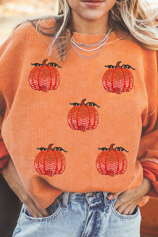 Esta sudadera con cordón con un estampado de calabaza con lentejuelas.